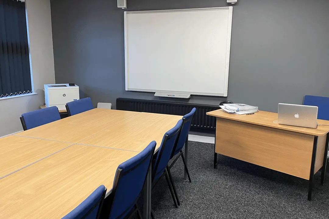 Photo showing the presentation end of the main conference room with the whiteboard